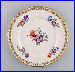 KPM, Berlin. Large antique plate in curved porcelain with hand-painted flowers