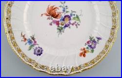 KPM, Berlin. Large antique plate in curved porcelain with hand-painted flowers